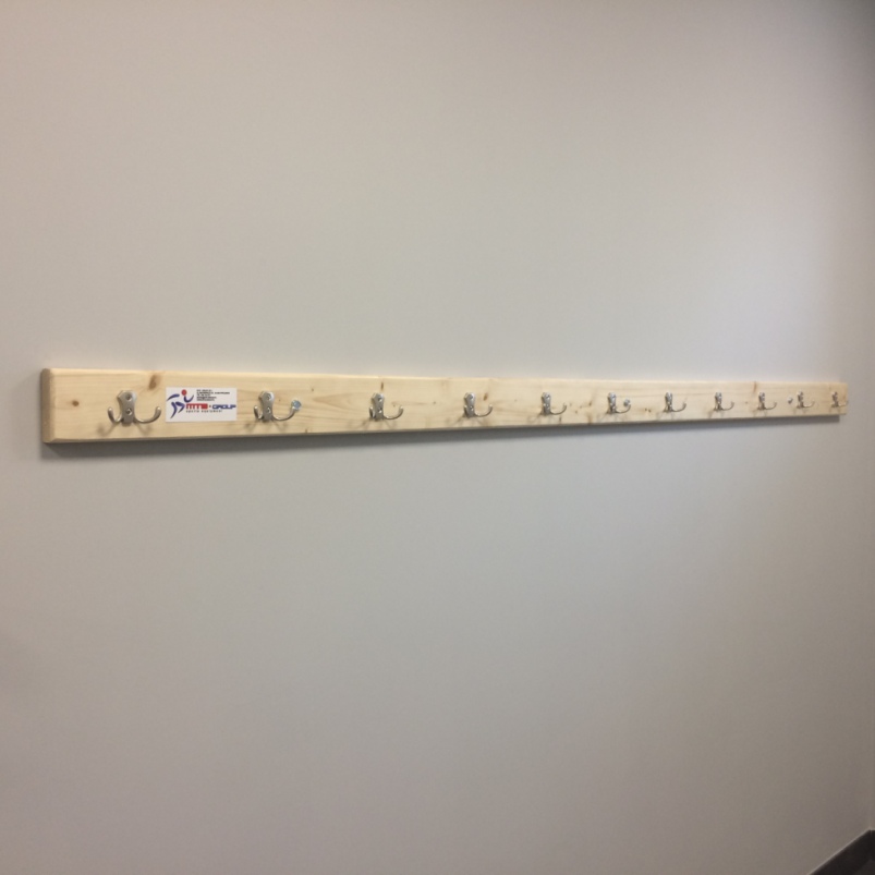 CHANGING ROOM HANGER ON WOODEN PANEL